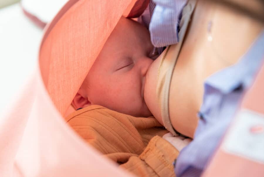 Beeld van moeder die baby borstvoeding geeft met Nursing Cocoon 